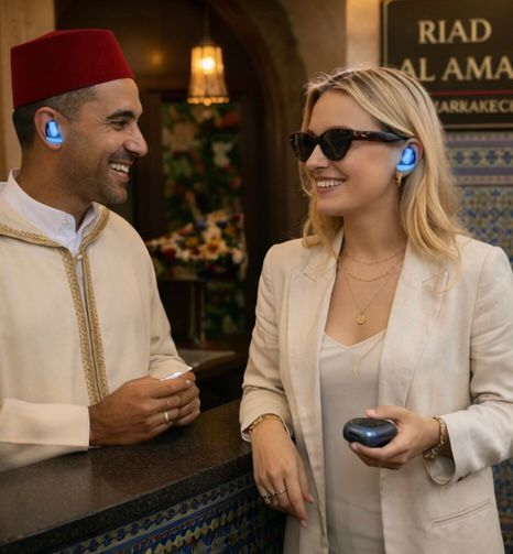 Swedish traveler and riad staff at reception using Takalam AI translating earbuds